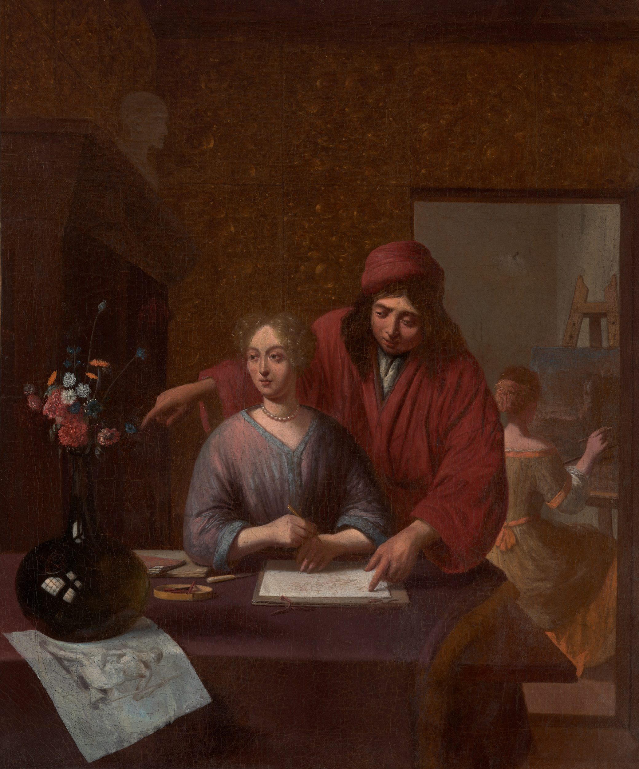 An Artist instructing two women in his studio